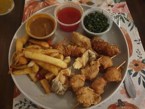 Wawin Special Combo: Crispy seaweed, crispy vegan wonton (2), vegan spring rolls (2), vegan chicken drumsticks (2), vegan chicken skewers in satay sauce (2), vegan prawn (2), serve at Wawin Vegan Chinese in Salford