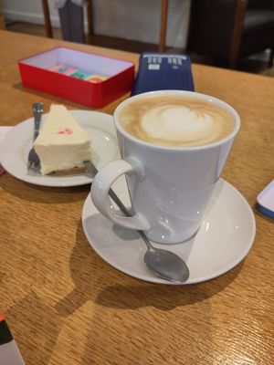 latte and cheesecake  (did have a raspberry on top but was already stolen by a toddler!) at World Peace Cafe in Leicester