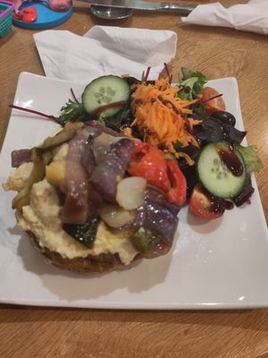 Jacket potato with humous and veg at World Peace Cafe in Leicester
