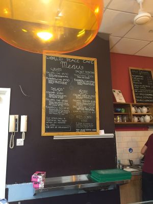 Clearly labelled vegan (vg) items on fully vegetarian menu at World Peace Cafe in Leicester