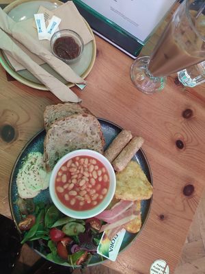 Vegan english breakfast with hummus, sausages, beams, hash browns and bacon at kave in West London