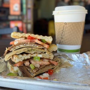 Bacon & Veggies Sandwich with oat milk latte  at Plain Talk Books & Coffee in Des Moines
