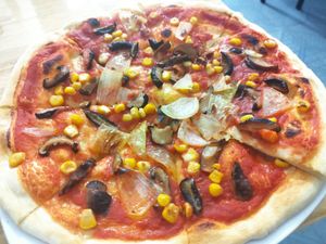 They only have 4 vegan topings. Corn, mushrooms, onion and olives. I took three of them. Stuff is really friendly. at Pizza Here in Ha Giang