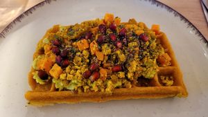 Sweet potato waffle with tofu scramble and avocado cream at Wake & Waffle in 
