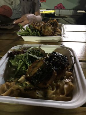 In front is teriyaki  broccoli and fried rice. In the back is a fettuccine dish with charred garbanzo steak.   at saVor in San Juan