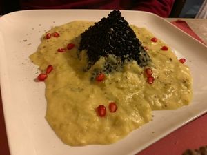 Black Veneto rice risotto with leek cream and pomegranate at L'Angolo Divino in Acqui Terme