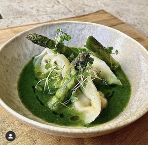 Table13 home made plant based ricotta tortellini with preserved lemon, terragon, and hazelnuts. In a nettle green sauce, grilled English asparagus, topped with micro rocket.  at Table 13 in Wheatley