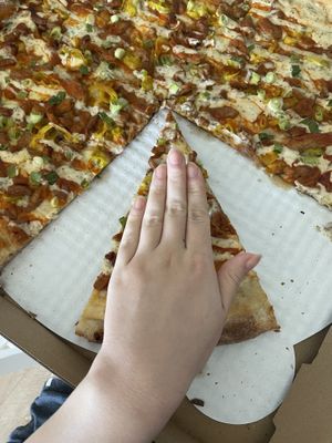 my hand compared to a slice for size   at TNT Pizza in San Diego