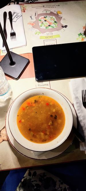 Vegetable soup with lemon slice at The Rooms Restaurant in Tirana