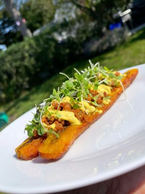 Sweet Plantain Boat filled with vegan beef, cashew queso & topped with microgreens  at Healthy As A Motha Vegan Kitchen in Brooklyn