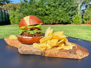 Soft Pretzel bun with a homemade eggplant & quinoa patty, topped with Arugula, tomatoes, & avocado  at Healthy As A Motha Vegan Kitchen in Brooklyn