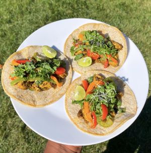 Curry Chik’n Tacos with grilled bell peppers, cilantro, microgreens, & lime  at Healthy As A Motha Vegan Kitchen in Brooklyn