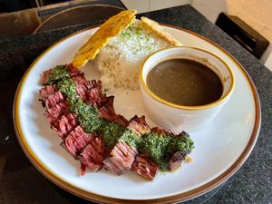 Chimichurri Chunk Steak with tostones, rice and beans  at Healthy As A Motha Vegan Kitchen in Brooklyn