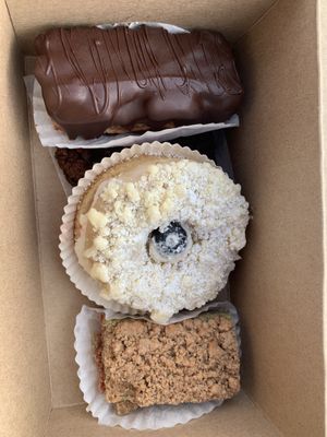 Rainbow cookie with mousse, filled doughnut, rainbow cookie with crumb, double chocolate chip cookie hiding underneath  at Pride Enjoy in Wading River