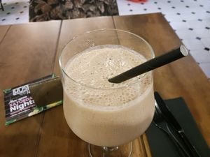 A banana date smoothie with paper straw at Hustle n' Flow in 