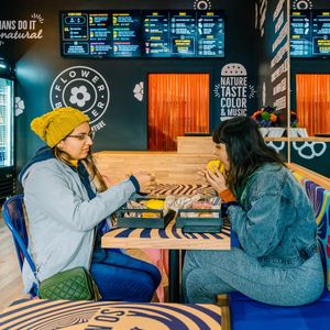 Friends enjoying the Spicy Chickpea & the Cherry Bomb. at Flower Burger in West Hollywood
