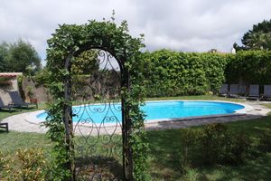 Nice little pool in the garden, so romantic view with the roses around and this green arc. at Colina Flora in Colares