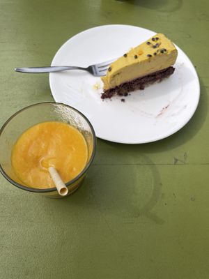 Amazing mango smoothie and nice cake.  at Alchemist Garden in Amsterdam