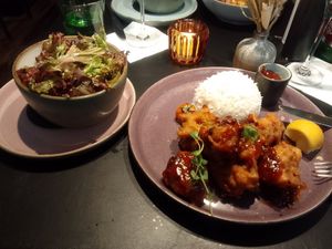 Cauliflower 'wings' with barbecue sauce, basmati rice, and green salad at Restaurant Führich in Vienna