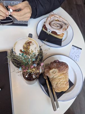 Raspberry kronut, oat cappuccino, cinnamon bun at The Hop Coffee in Sheffield