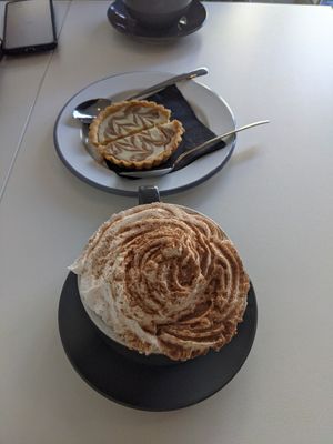 Pumpkin spiced latte & VG whipped cream & miso white choc tart at The Hop Coffee in Sheffield