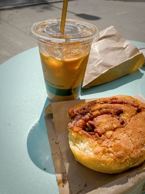 Horchata iced latte and a cinnamon roll   at Gallivant Coffee in Woodfin