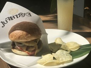 Vegan, classic cheeseburger with grilled pineapple served with taro chips and organic ginger ale. at Earthful Cafe in Kitanakagusuku