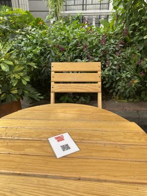 Outdoor seating w/digital menu  at Tamales Madre in Mexico City