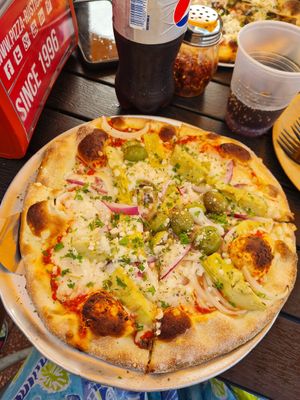 Pizza with vegan cheese, artichokes, olives and red onion at Pizza Rustica in Miami Beach