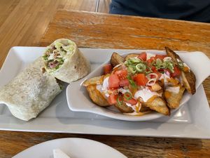 The seitan wrap with a side of loaded potato wedges.  at Rise Above in St Catharines