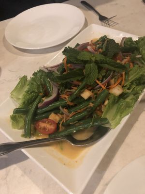 Fries tofu, green beans, tomato salad in a coconut lime dressing  at Araya's Place - University District in Seattle