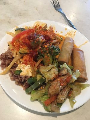 Buffet pile of rice, veggies, red curry, and tasty spring rolls at Araya's Place - University District in Seattle