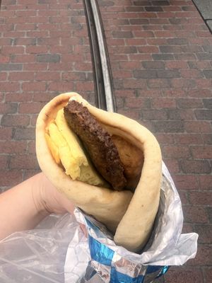 Impossible sausage, just egg, tater tots and vegan cheese on a very fluffy bread  at Disneyland - Shawarma Palace - Food Stand in Anaheim