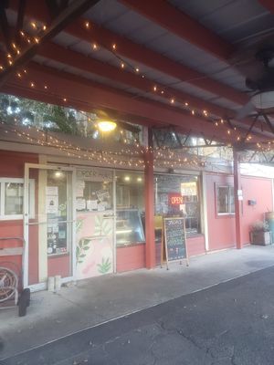 Covid ordering set up, cashier speaks through microphone and you reply through the intercom, and get your food from the small door below the window at Sweet Pea Cafe in Tallahassee
