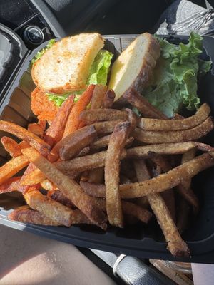 Buffalo fried tofu sandwich on oat bread and sweet potato fries   at Sweet Pea Cafe in Tallahassee