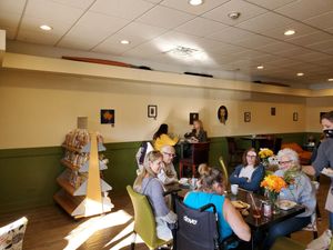 Bread stand and dining area at UpRising bakery & cafe in Lake In The Hills