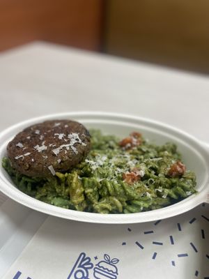Pesto pasta with a lentil burger  at Holy Plants in Lima