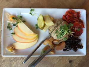 Paté Platter: Lentil-pecan paté, red onion confit, house made pickles, croccantini, fresh fruit. at Cafe Flora in Seattle