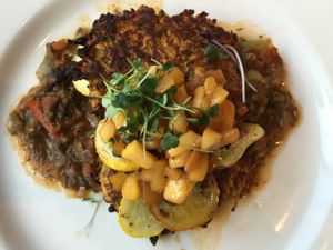 Summer Yuca Cakes: Cassava & carrot cakes, sweet pepper sofrito, baby summer squash & spicy peach chutney. at Cafe Flora in Seattle