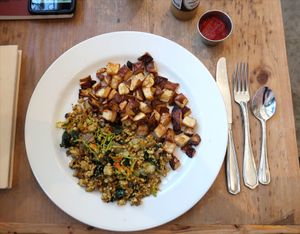 The vegan version of the Summer Squash Scramble. Seasoned tofu, sauteed summer squash & zucchini grilled Vidalia onions, kale, squash blossoms and a side of potatoes.  at Cafe Flora in Seattle