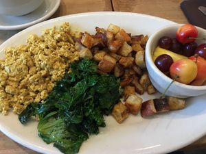 vegan breakfast platter : scrambled spiced tofu, potatoes, steamed kale and fruits at Cafe Flora in Seattle