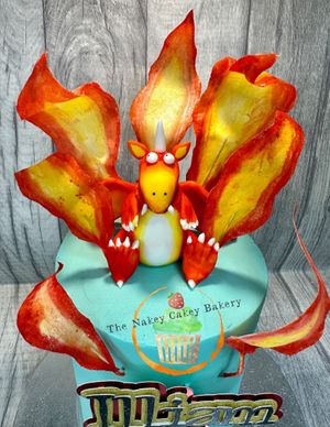 Gluten-free/vegan red velvet cake with handmade fondant Zog and wafer paper flames 🔥  at The Nakey Cakey Bakery in Castletown