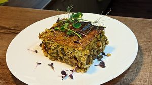 Traditional Bulgarian meal with wholegrain brown rice, mushrooms, spinach and top filling made of sunflower seeds and herbs at Vitu Kitchen - кухня ВИТУ in Plovdiv