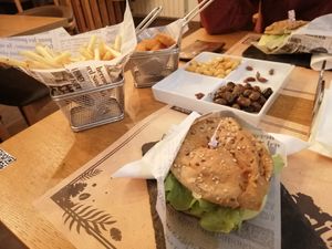 Pickled beans, olives, nuggets, vegan burger and fries.  at Lima Bar in Viana Do Castelo