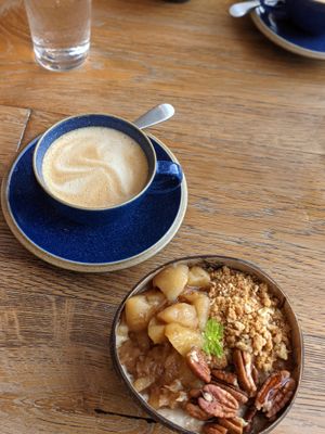 Goawesome porridge with apples, granola, pecans in coconut bowl at Hata in Edinburgh