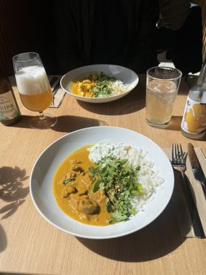 Jackfruit korma with rice and tzatziki and chickpea & cauliflower curry with rice.  at Cultivate Food in Oslo