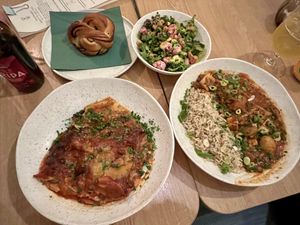 Two mains a side salad and cinnamon bun   at Cultivate Food in Oslo