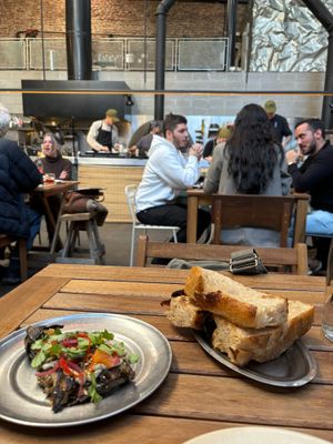 Berenjena platito (GET IT!!) with chibatta bread with a view of the kitchen at Chuí in Buenos Aires
