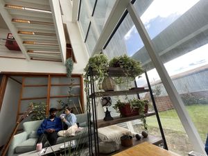 Communal table and chill out spot on the sofa  at Hablemos Coco Cafe in Puerto Natales