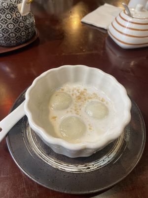 Rice balls filled with black sesame in ginger coconut sauce  at Vin in Vienna